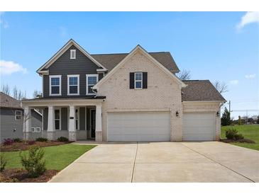 Two story home with a three car garage, white brick and gray siding at 108 Camdale Ct, Mcdonough, GA 30252