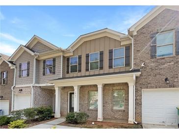 Brick front townhouse with two-car garage and porch at 1861 Old Dogwood, Jonesboro, GA 30238
