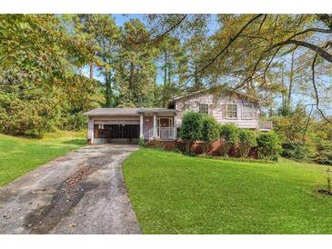 Ranch home with a two-car garage and a nicely landscaped yard at 3664 Broadview Ct, Decatur, GA 30032