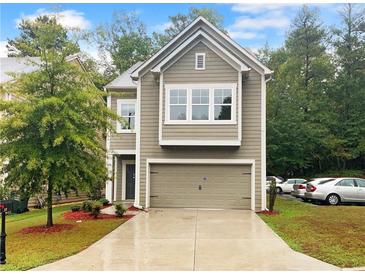 Two-story house with gray siding, a two-car garage, and a landscaped front yard at 57 Westend Way, Hiram, GA 30141