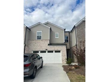 Modern two-story townhome with attached garage and landscaping at 950 Sunny Lake Dr, Lawrenceville, GA 30043