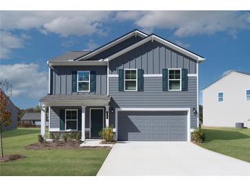 Two-story house with gray siding and a two-car garage at 3290 Forest Green Dr, Douglasville, GA 30135