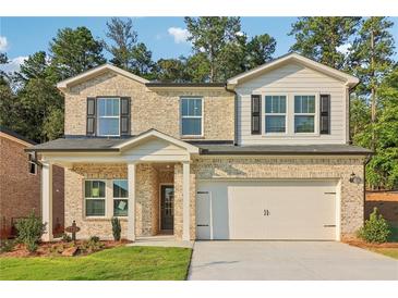 Two-story brick home with a two car garage at 7739 Richmond Trl, Fairburn, GA 30213