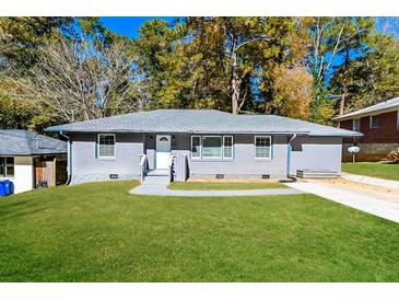 Gray house with green lawn, walkway, and driveway at 1868 Longdale Dr, Decatur, GA 30032