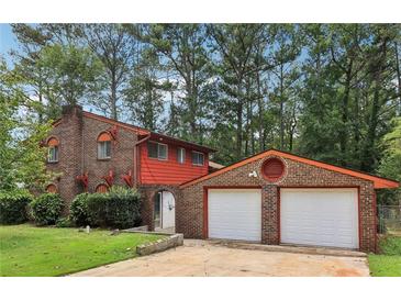 Two-story brick home with attached two-car garage at 8263 Chestnut Dr, Jonesboro, GA 30238