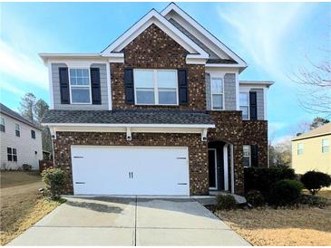 Two-story brick home with a white garage door and landscaping at 2414 Allsborough Way, Dacula, GA 30019