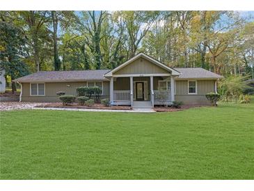Single-story house with green lawn and covered porch at 3225 Fern Dr, Tucker, GA 30084