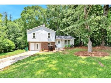 Ranch home with attached garage and front yard at 5108 Galbraith Cir, Stone Mountain, GA 30088