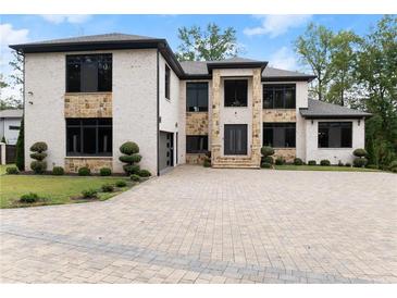 Luxury two-story home with stone accents and large driveway at 2635 Camp Branch Rd, Buford, GA 30519
