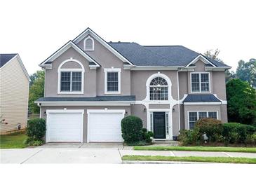 Two-story house with a gray stucco exterior, two car garage, and mature landscaping at 4000 Longlake Dr, Duluth, GA 30097
