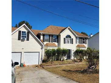 Two-story house with attached garage and landscaping at 4769 Snap Creek Ln, Decatur, GA 30035