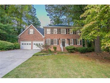 Brick house with two-car garage and landscaped yard at 2097 Kolb Ridge Sw Ct, Marietta, GA 30008