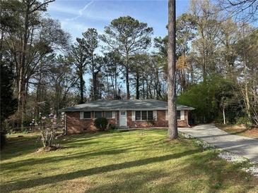 Brick ranch house with a long driveway and mature trees at 6441 Dunmoor Dr, Jonesboro, GA 30236