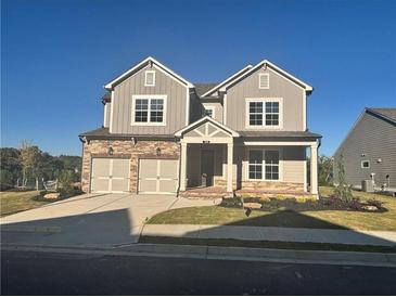 Two-story house with three-car garage and front yard at 328 Willow Cv, Canton, GA 30114