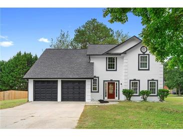 Two-story house with a two-car garage and manicured lawn at 1125 Reunion Sw Pl, Atlanta, GA 30331