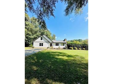 Charming white house with green lawn at 2735 Sandy Creek Cir, Loganville, GA 30052