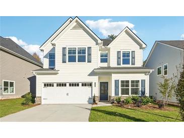 Two story house with white siding and a two car garage at 11820 Rizvan Pl, Covington, GA 30014