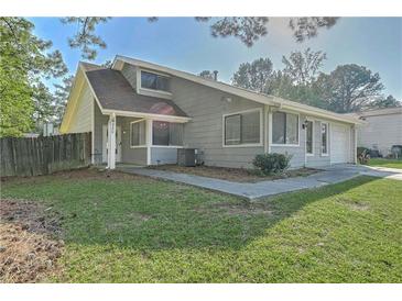 Gray two-story house with a landscaped yard and attached garage at 4650 Heather Ct, Union City, GA 30291