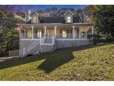 Two-story house with a wraparound porch and landscaped yard at 530 S Lost Lake S Cv, Villa Rica, GA 30180