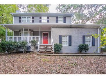 Two-story house with red front door and covered porch at 1507 Hillside Se Dr, Conyers, GA 30094