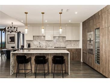 Modern kitchen with large island and stainless steel appliances at 3107 Peachtree Road Ne Unit #1803, Atlanta, GA 30305