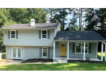 Newly renovated two-story home with a yellow door at 5364 Cedar Rock Dr, Stonecrest, GA 30038