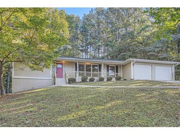 House exterior with two-car garage and yard at 443 Creekwood Pass, Dallas, GA 30157