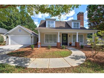 Charming house with a wrap-around porch, attached garage, and landscaped yard at 12 Riverwood Lndg, Dallas, GA 30157