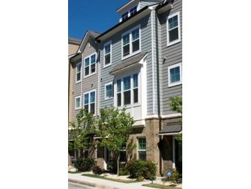 Three story townhouses with gray siding and landscaping at 2161 Colvin Nw Ct, Atlanta, GA 30318