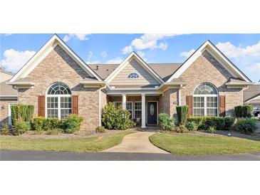 Brick house with brown shutters and a well-manicured lawn at 945 Savannah Commons Ne Dr # 1, Kennesaw, GA 30144