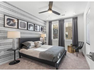 Modern bedroom with a striped accent wall and a comfy bed at 371 Grant Se Cir # 1814, Atlanta, GA 30315