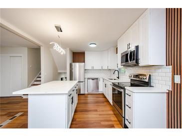 Modern kitchen with white cabinets, stainless steel appliances, and quartz countertops at 3900 Hilton Cts, Decatur, GA 30035