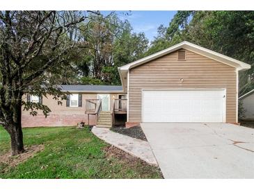 Ranch home with attached garage and landscaping at 4111 Wrexham Dr, Snellville, GA 30039