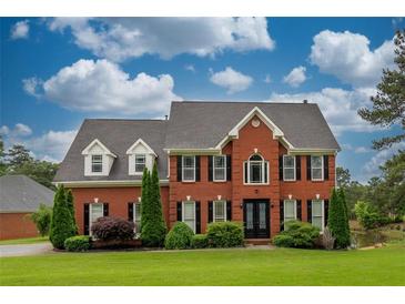 Brick two story house with manicured lawn at 2505 Westchester Way, Conyers, GA 30013