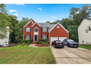Brick house with a two-car garage and spacious yard at 1812 Beckley Nw Pl, Kennesaw, GA 30152