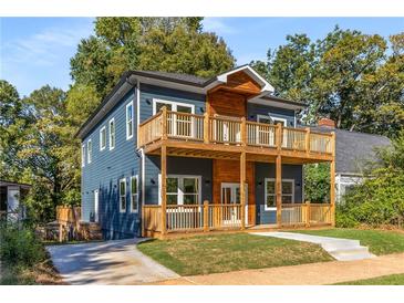 Stunning two-story home with blue siding, wooden accents, and large deck at 971 Washington Sw Pl, Atlanta, GA 30314