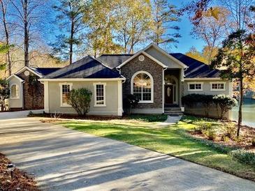 Ranch style home with stone accents and landscaped lawn at 7149 Burnside Ct, Villa Rica, GA 30180