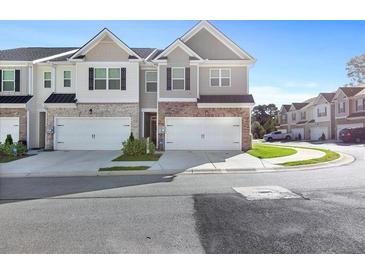 Modern two-story townhome with two-car garage and attractive landscaping at 179 Hampton Cir, Mcdonough, GA 30253