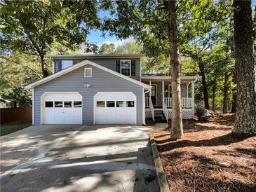 Two-story house with gray siding, two-car garage, and porch at 384 Russell Ridge Dr, Lawrenceville, GA 30043