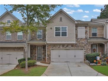 Two-story townhome with two-car garage and landscaping at 5820 Keystone Pt, Lithonia, GA 30058