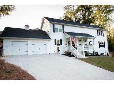 Two story home with white siding and two car garage at 4619 Spring St, Acworth, GA 30101