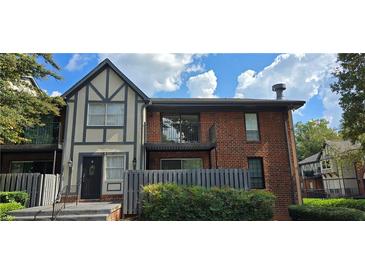 Brick building with balcony and landscaping at 6851 Roswell Rd # O9, Atlanta, GA 30328