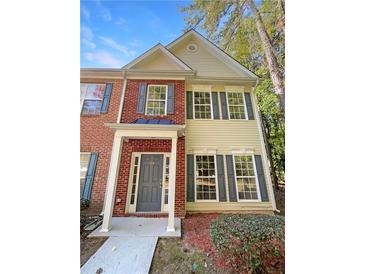 Two-story townhome with gray door and brick facade at 20 Pine Canyon Sw Dr # 24, Atlanta, GA 30331