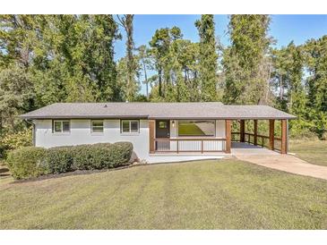 Ranch style home with covered porch and landscaped yard at 3611 Hillsborough Ln, Decatur, GA 30032