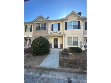 Two-story townhouse with a yellow exterior and a walkway leading to the entrance at 2805 Vining Ridge Ter, Decatur, GA 30034