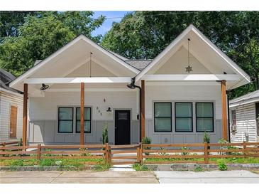 Charming craftsman style home with a white exterior, wood accents, and a landscaped front yard at 865 Mcdaniel Sw St, Atlanta, GA 30310