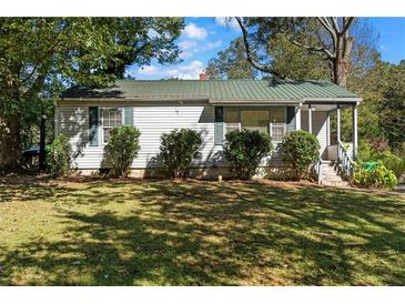White house exterior with green metal roof and landscaping at 3589 Orchard Cir, Decatur, GA 30032