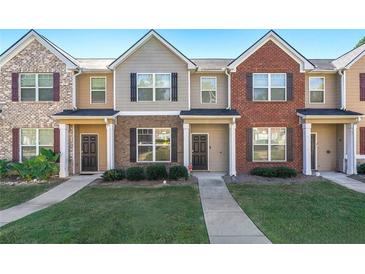 Three-unit townhouse building with brick and siding exteriors at 6327 Olmadison Pl, South Fulton, GA 30349