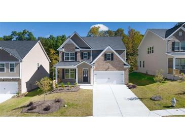 Two-story brick home with a two-car garage and landscaped lawn at 1898 Lacebark Elm Way, Lawrenceville, GA 30045