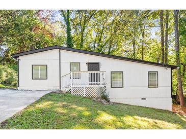 Charming ranch home with a white exterior, deck, and landscaped yard at 2396 Abner Nw Pl, Atlanta, GA 30318